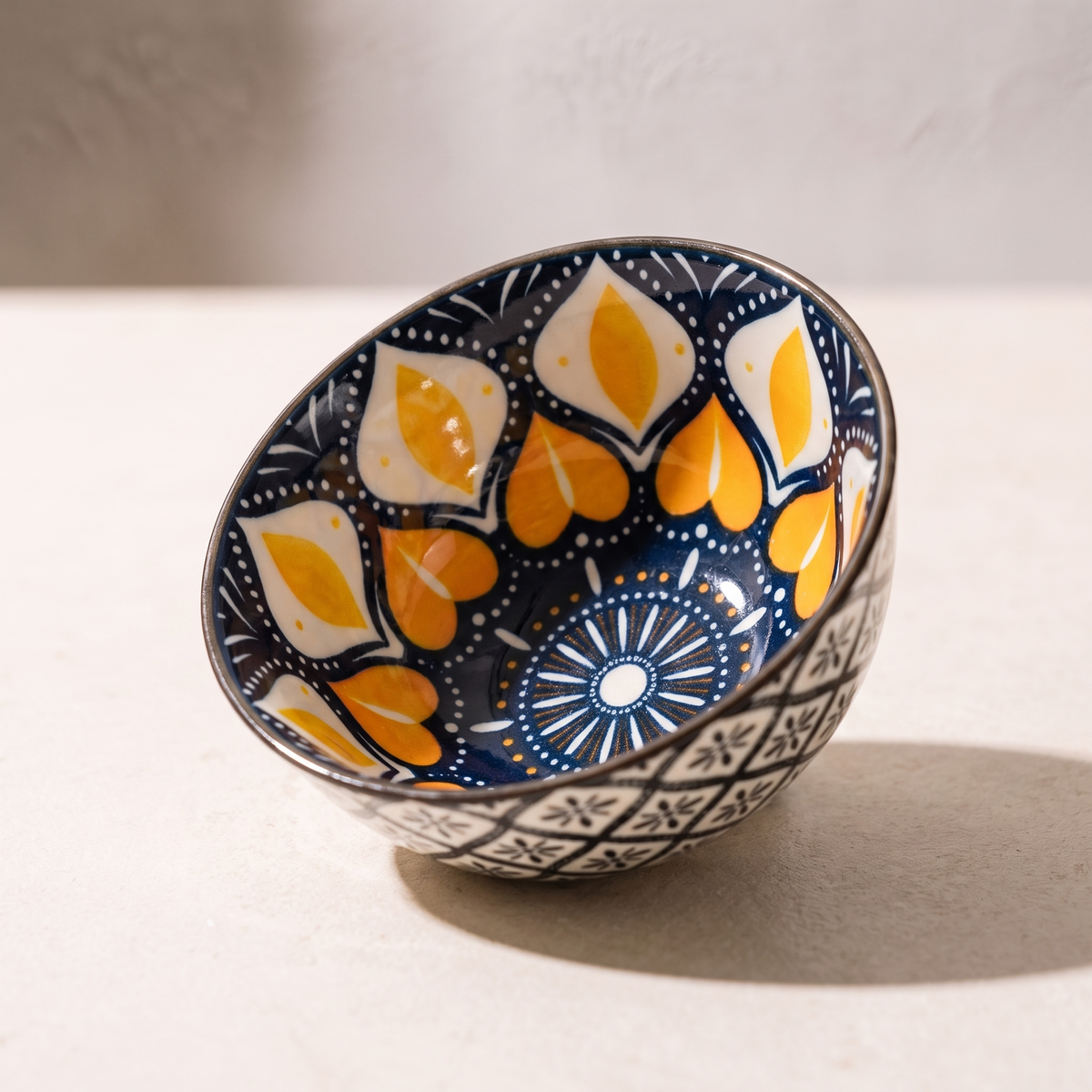 Close view of the hand painted pattern and the lattice band on the outside of one bowl