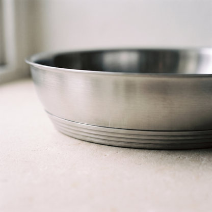 Close view of the thick banded multi layer base and the brushed steel pan wall